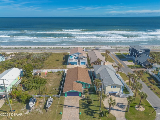 birds eye view of property featuring a water view and a beach view