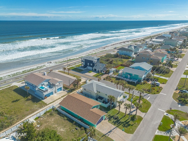 drone / aerial view with a view of the beach and a water view