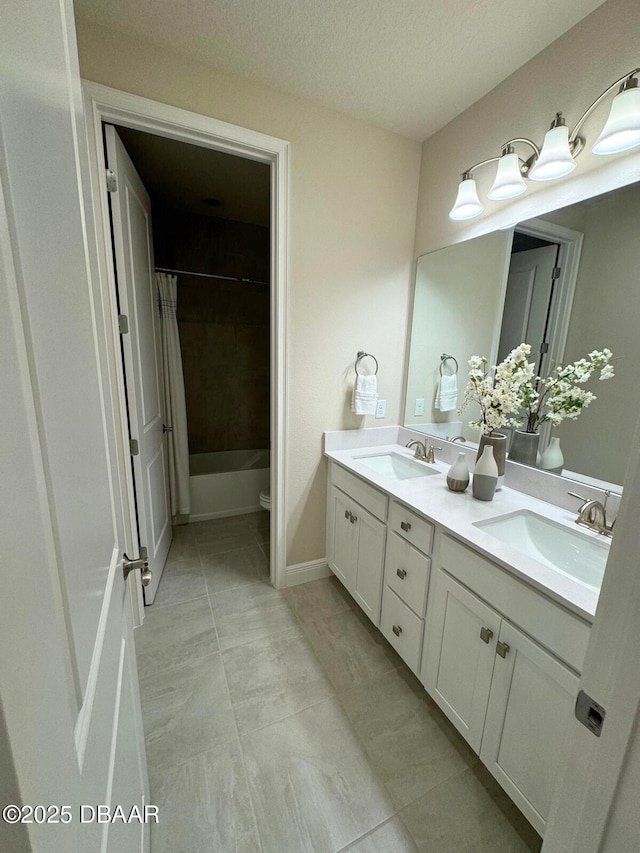 full bathroom featuring vanity, shower / tub combo, a textured ceiling, and toilet