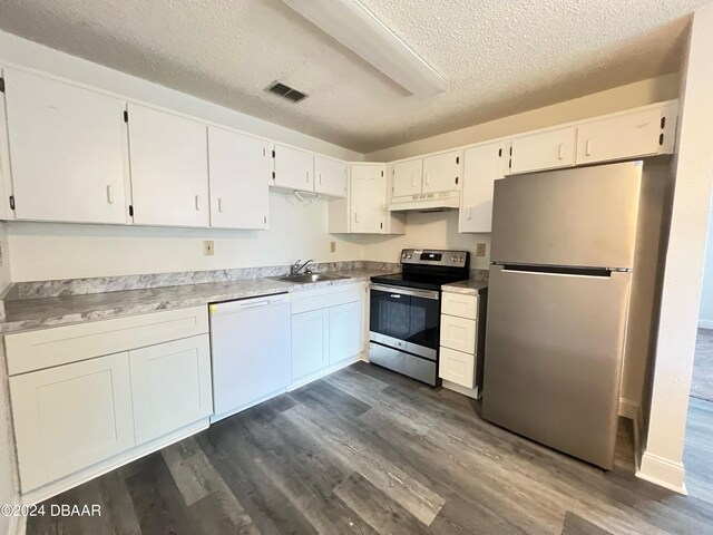 kitchen with white cabinetry, appliances with stainless steel finishes, a textured ceiling, dark hardwood / wood-style flooring, and sink