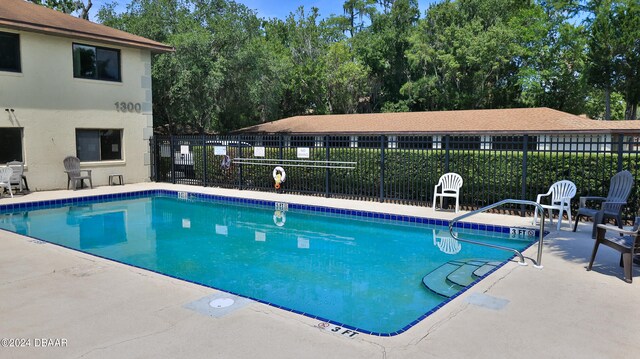 view of swimming pool with a patio area