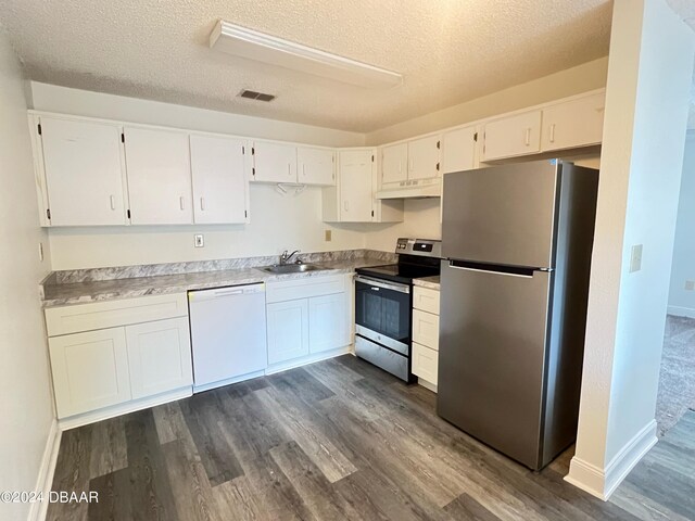 kitchen with dark wood-type flooring, white cabinetry, appliances with stainless steel finishes, and premium range hood