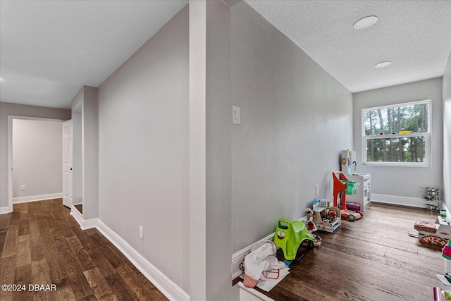 interior space featuring dark wood-type flooring and a textured ceiling