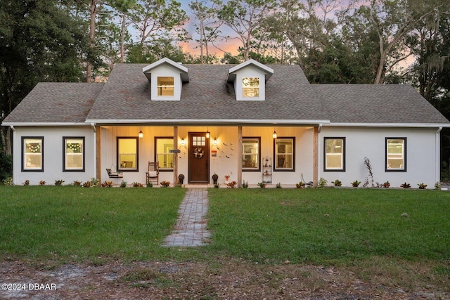 view of front of property with a yard and a porch