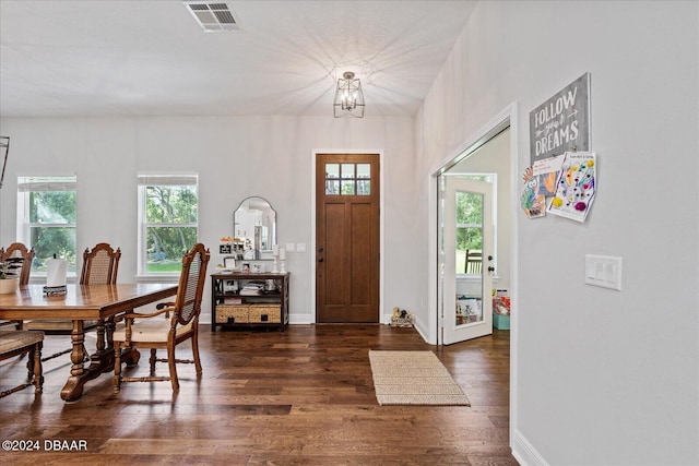 entryway featuring a chandelier, a healthy amount of sunlight, and dark hardwood / wood-style flooring