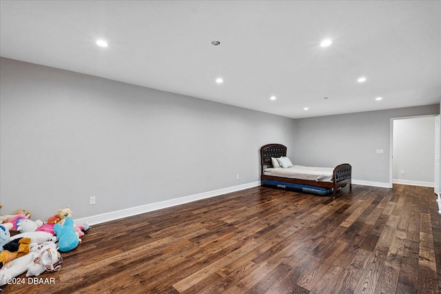 bedroom with dark hardwood / wood-style floors