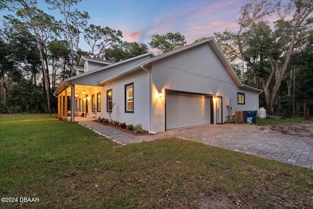 view of front of house featuring a garage and a lawn