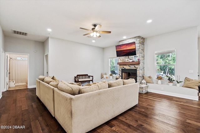 living room featuring a fireplace, dark hardwood / wood-style flooring, and ceiling fan