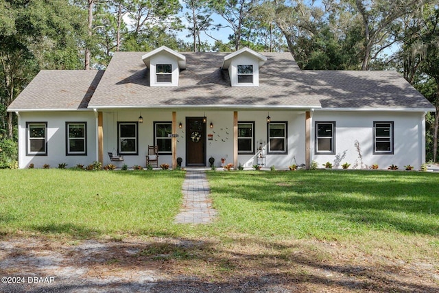 cape cod-style house with a front lawn and covered porch