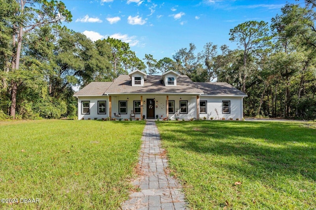 cape cod home with a front yard