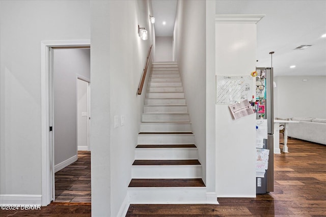 staircase featuring wood-type flooring