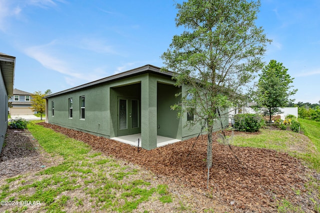 view of property exterior with a patio