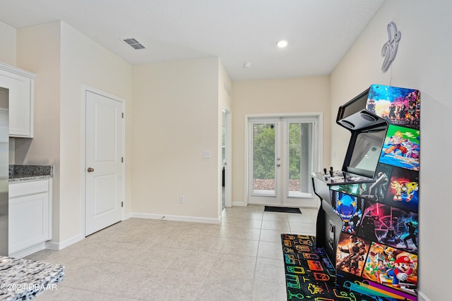 rec room featuring french doors and light tile patterned floors