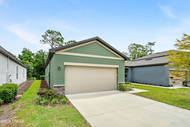 view of front of home featuring a garage and a front lawn