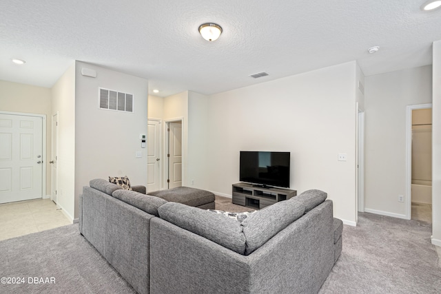 living room featuring light colored carpet and a textured ceiling