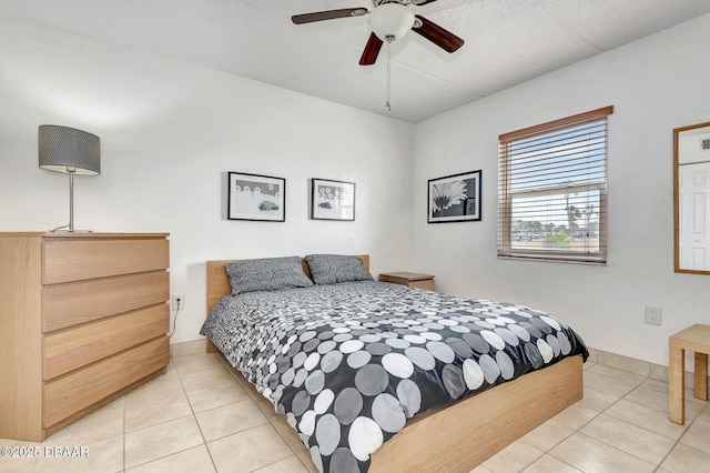 bedroom featuring a ceiling fan and light tile patterned floors