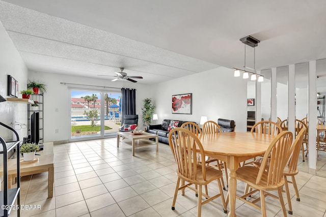 dining space featuring ceiling fan and light tile patterned floors