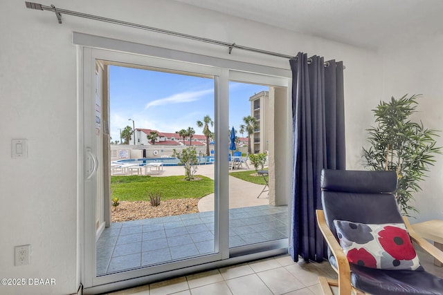 doorway to outside with plenty of natural light and light tile patterned floors