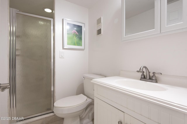full bath with vanity, tile patterned flooring, a shower stall, and toilet