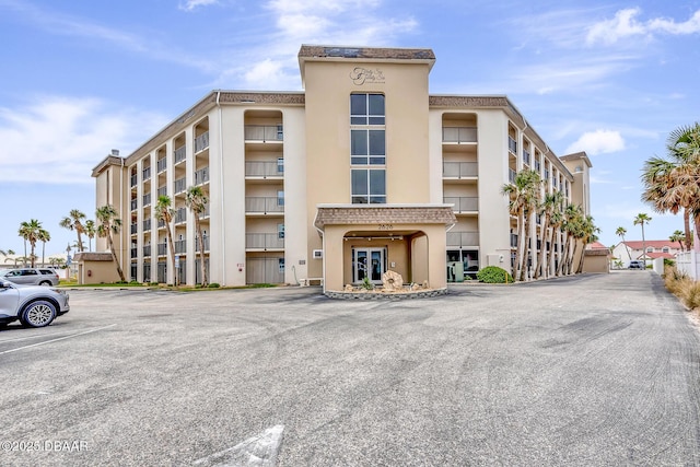 view of building exterior with uncovered parking