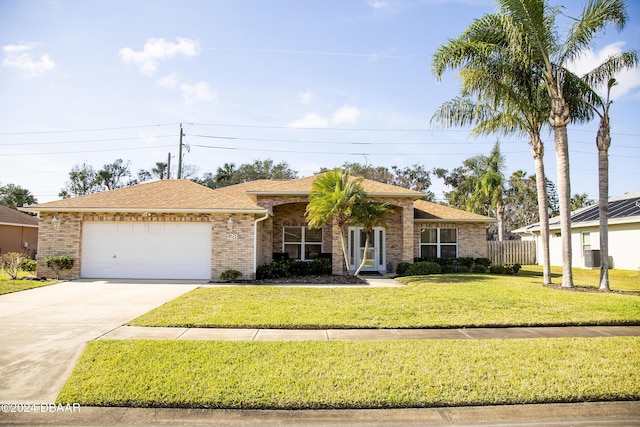 ranch-style home with a front yard and a garage