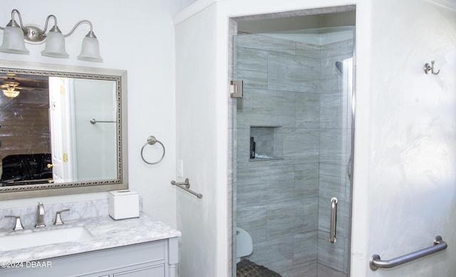 bathroom featuring vanity and an enclosed shower