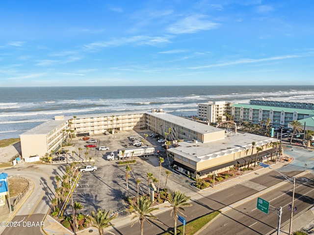 birds eye view of property with a water view and a view of the beach