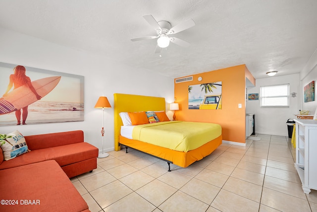 tiled bedroom featuring a textured ceiling and ceiling fan