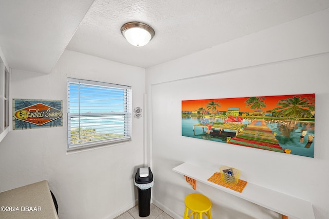 interior space with tile patterned flooring and a textured ceiling