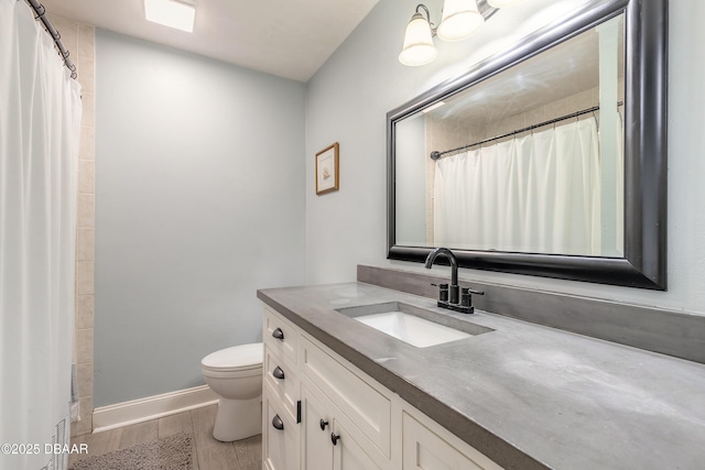 full bathroom featuring vanity, toilet, baseboards, curtained shower, and wood finished floors