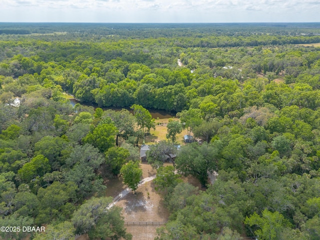 birds eye view of property with a view of trees