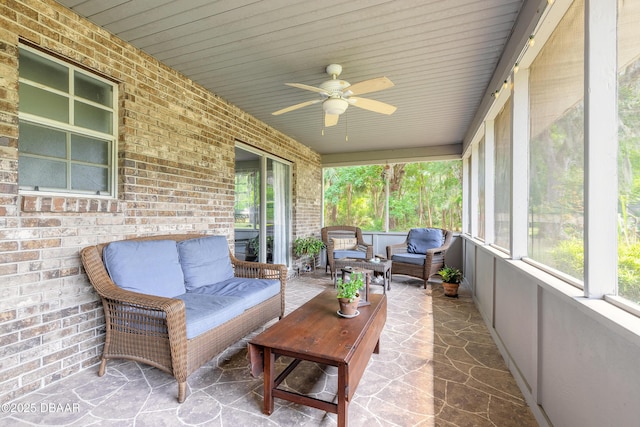 sunroom / solarium with ceiling fan and outdoor lounge area