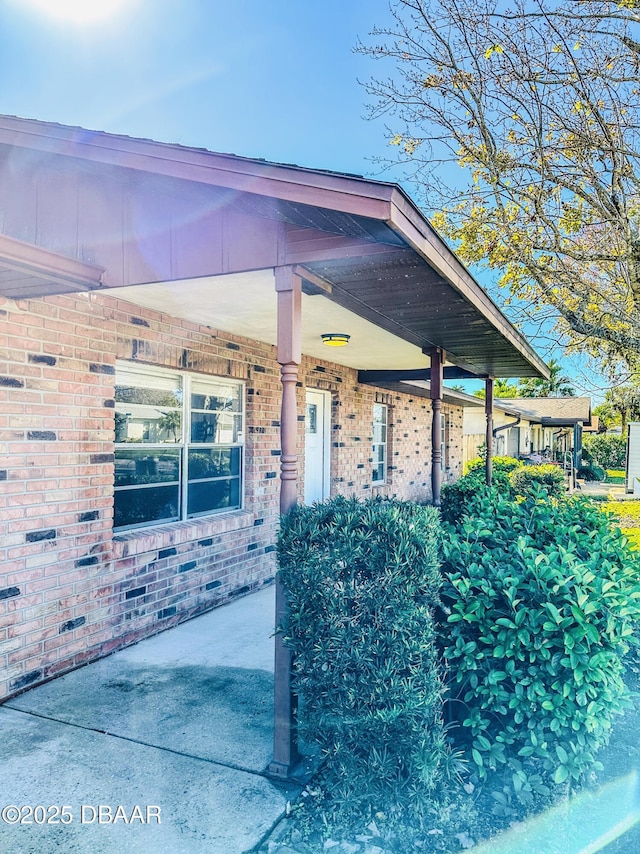 doorway to property featuring brick siding