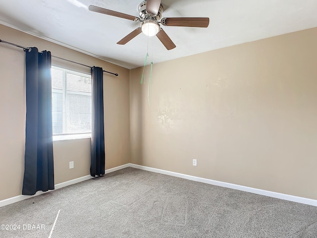 unfurnished room featuring ceiling fan and carpet