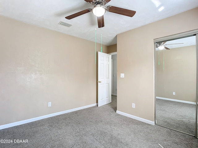 unfurnished bedroom with carpet floors, ceiling fan, and a closet