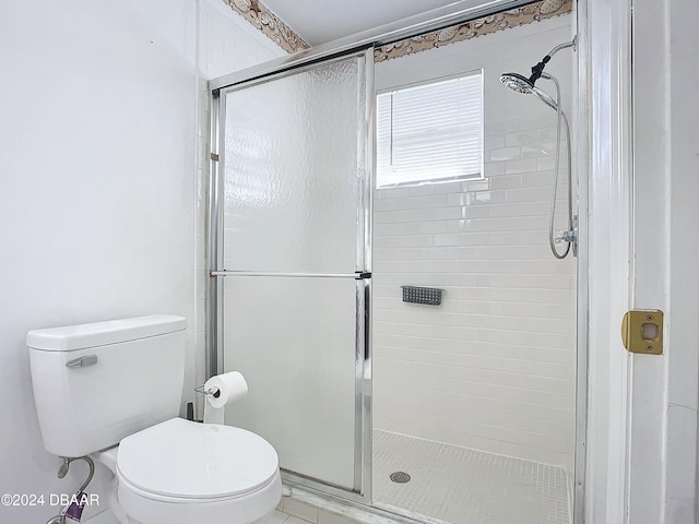 bathroom featuring walk in shower and toilet