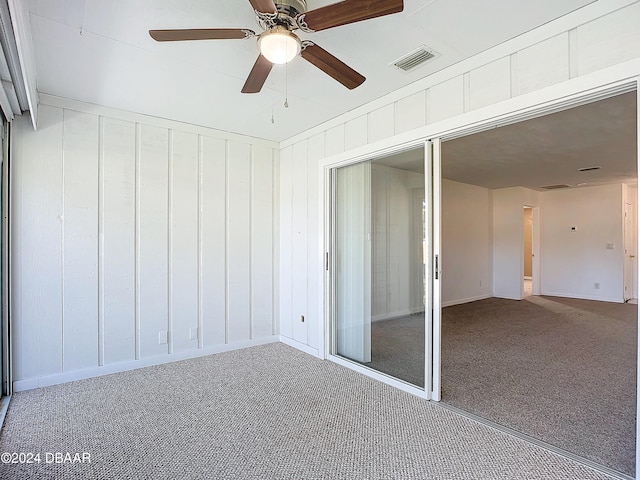 unfurnished sunroom with ceiling fan