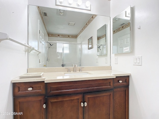 bathroom with walk in shower and vanity