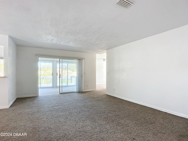 empty room featuring carpet flooring and ceiling fan