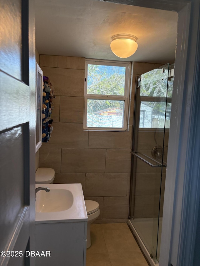 bathroom with a stall shower, tile patterned flooring, vanity, and toilet