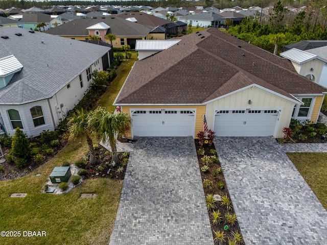 birds eye view of property with a residential view