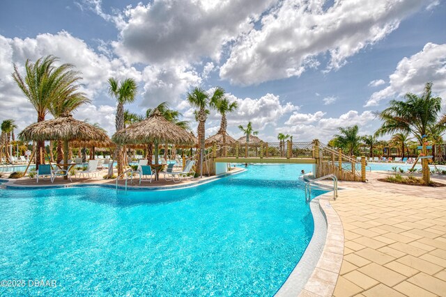 community pool featuring a gazebo, fence, and a patio