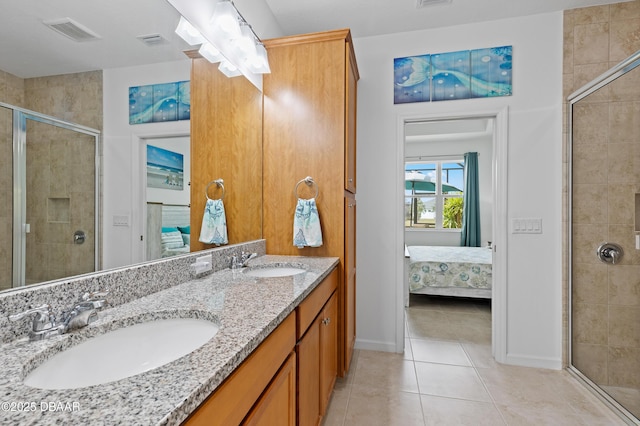 ensuite bathroom featuring visible vents, a shower stall, ensuite bath, and a sink