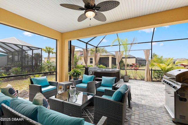 view of patio with a ceiling fan, a grill, outdoor lounge area, a lanai, and a hot tub