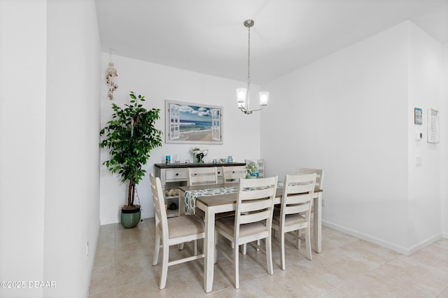 dining room featuring light tile patterned floors, baseboards, and a chandelier