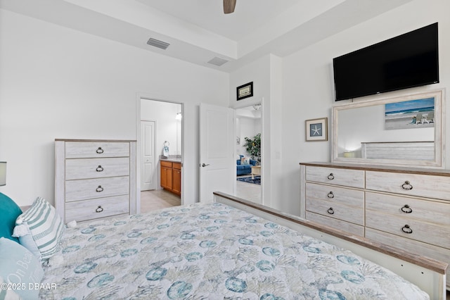 bedroom featuring visible vents, ensuite bathroom, and ceiling fan