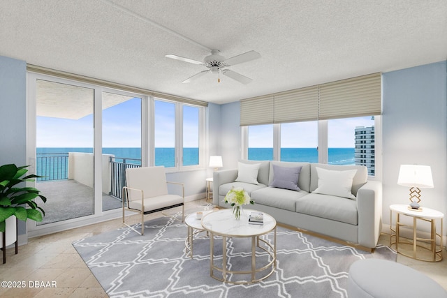 2987 S Atlantic Ave Unit 903, Daytona Beach Shores, FL 32118 - living area with a water view, a ceiling fan, and a textured ceiling