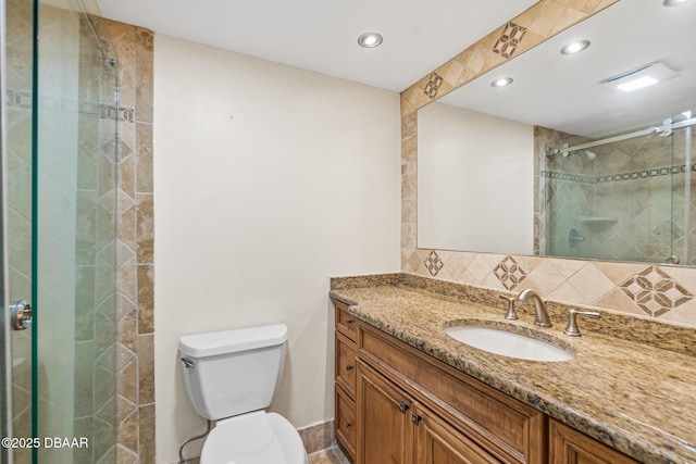 2987 S Atlantic Ave Unit 903, Daytona Beach Shores, FL 32118 - full bathroom with vanity, toilet, tasteful backsplash, a stall shower, and recessed lighting