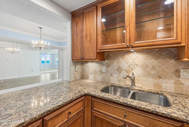 2987 S Atlantic Ave Unit 903, Daytona Beach Shores, FL 32118 - kitchen with a sink, brown cabinets, tasteful backsplash, and crown molding