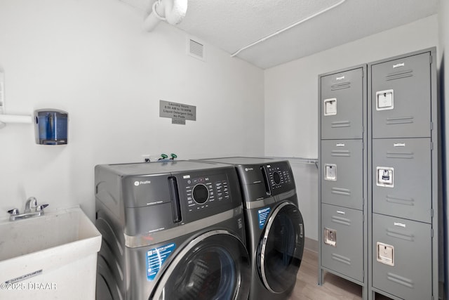 2987 S Atlantic Ave Unit 903, Daytona Beach Shores, FL 32118 - washroom featuring independent washer and dryer and wood finished floors